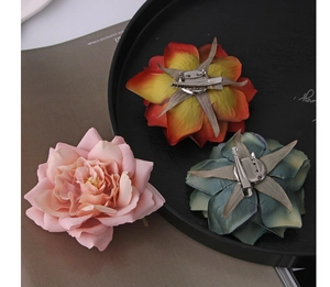 Detail of silk flower clips showing back metal brooch pin and hair clip mechanism