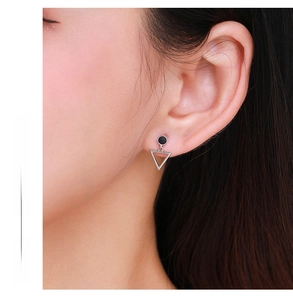 Close-up of minimalist S925 silver hollow triangle earrings worn on a model's ear