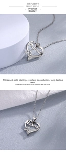 Detail of silver Mama heart pendant with butterfly accents and sparkling cubic zirconia