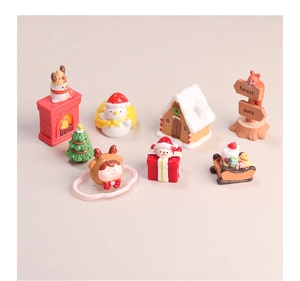 Macro detail of eight Christmas resin charms including Santa, snowman and gingerbread house