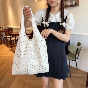 Polka dot canvas tote bag detail showing large capacity and black dots on white fabric