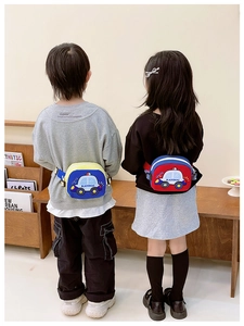 Rear view of children wearing cartoon car waist bags in blue and red colors