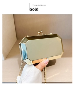 Macro detail of gold octagonal evening clutch bag with spherical clasp and metal chain