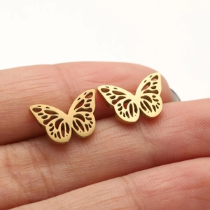 Close-up of gold butterfly stud earrings with hollow wings held between fingers