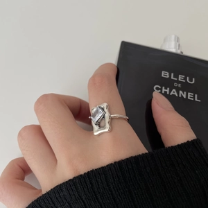 Detailed view of an S925 sterling silver square zircon ring on a finger with a modern design
