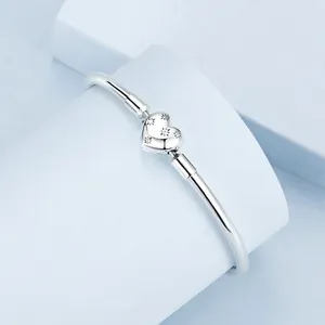 Minimalist 925 sterling silver open bangle featuring a sparkling heart star pendant