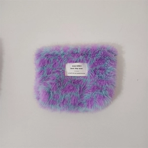 Macro detail of plush purple and light blue leopard print makeup bag with texture