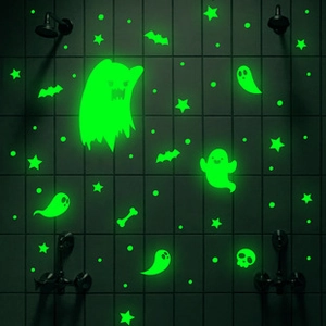 Luminous Halloween wall stickers featuring ghosts and bats on black bathroom tiles