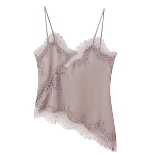 Detail of dusty pink satin camisole top with delicate lace trim on white background