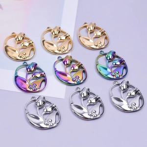 Macro shot of oval tulip pendants in gold, silver and colorful finishes for DIY jewelry