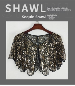 Close-up of black mesh sequin shawl with golden wave patterns and scalloped edges