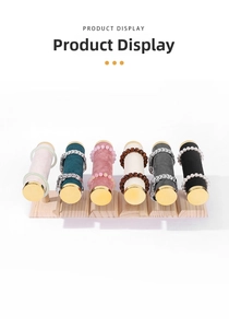Detail of wooden display stand with six colorful velvet rollers for watches and jewelry