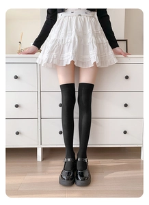 Detail shot of high-density black velvet over-the-knee compression socks on a model