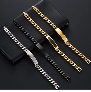 Close-up of four stainless steel Cuban link ID bracelets in gold, silver and black finish