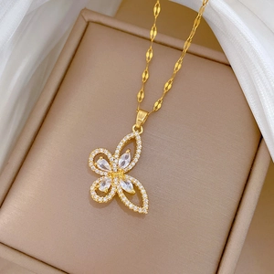 Close-up of golden hollow butterfly pendant with sparkling zircons in a jewelry box