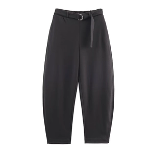 Close-up of high-waist velvet trousers featuring a matching belt and metal D-ring buckle