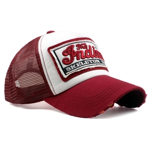 Detail of burgundy trucker hat with vintage embroidery and breathable white mesh back