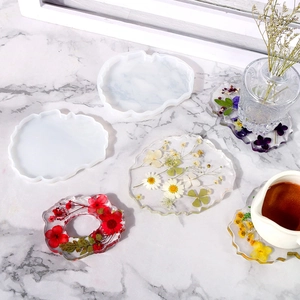 DIY silicone molds for irregular coaster crafts featuring dried flower resin designs