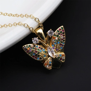 Macro shot of gold butterfly necklace pendant with vibrant multi-colored zircon stones