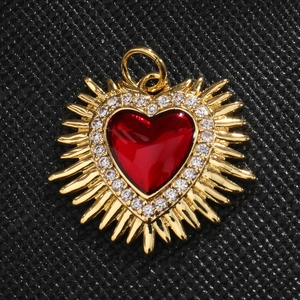 Gold heart pendant with large red gemstone and sparkling sunburst crystal halo design