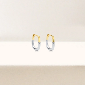 Macro shot of U-shaped S925 sterling silver earrings with dual-tone finish and hallmark