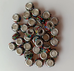 Pile of multi-colored rhinestone beads with 5mm silver metal large eyelet holes