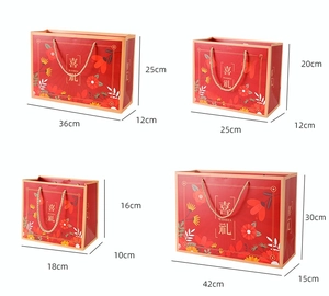 Detail view of four sizes of red Chinese gift bags with gold handles and dimensions