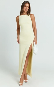 Detail view of the high side slit and soft draped fabric on the pale yellow maxi dress