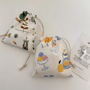 Detail of canvas drawstring pouches with cartoon castle and ice cream pattern illustrations