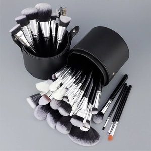 Macro view of a 32-piece professional makeup brush set with black PU leather storage case