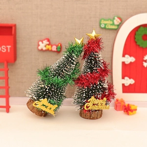 Mini artificial Christmas cedar trees with snowy tips and golden star toppers for desktop decor