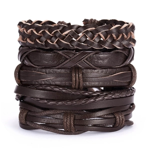 Macro view of multi-layered brown braided leather bracelet set for men in punk style