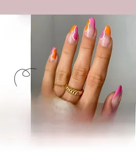 Close-up of almond press-on nails with pink orange blocks and white wavy lines