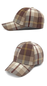 Detail of vintage plaid baseball cap with classic brown and red pattern on white background