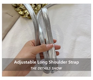 Detail of silver metallic textured adjustable shoulder strap with thick gold chain link