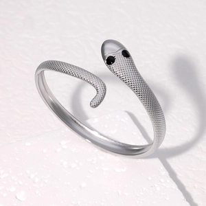 Silver snake-shaped stainless steel cuff bracelet with detailed scales and black eye accents