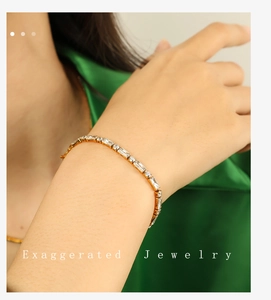 Close-up of gold-plated zircon bracelet with alternating rectangular and round crystals