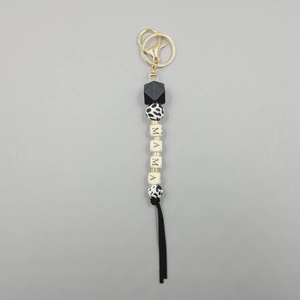 Detail of MAMA letter silicone bead keychain with leopard print and black tassel fringe