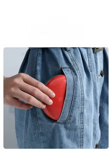 Close-up of portable medicine box being placed into a pocket for daily travel