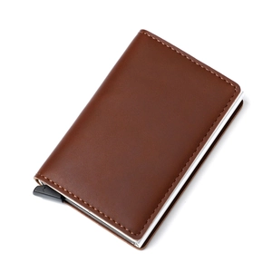 Detail of brown leather RFID card holder featuring smooth automatic pop-up mechanism