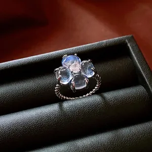 Sparkling zircon flower open ring with light blue petals and twisted silver band