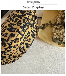 Detail view of leopard print canvas bag with rounded edges and secure zipper closure