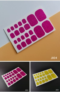 Detailed view of magenta and yellow glitter toe nail wraps showing shiny texture