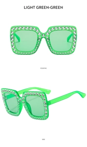 Macro detail of luxury square sunglasses in light green with sparkling rhinestone crystals