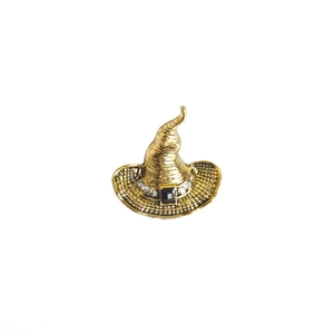 Detail of vintage gold wizard hat brooch with black gemstone and rhinestones