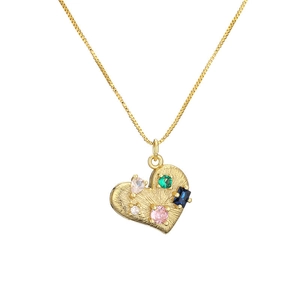 Detail of heart pendant necklace with colorful gems in gold finish on white background