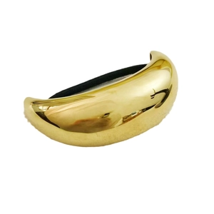Minimalist golden stainless steel hair cuff accessory for elegant ponytails on white background