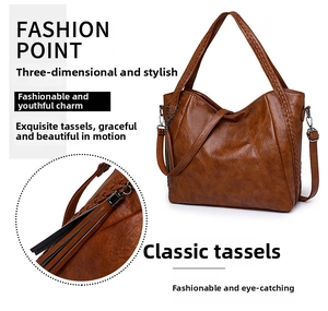Detailed macro view of brown pebbled leather texture with elegant long tassel pendant