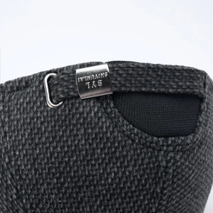 Close-up of adjustable silver metal buckle with brand logo on gray baseball cap