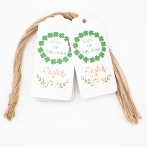 Close-up of white Thank You tags with green clover wreath and Luck of the Irish text